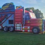 Große bunte Hüpfburg in Lastwagenform im Freien